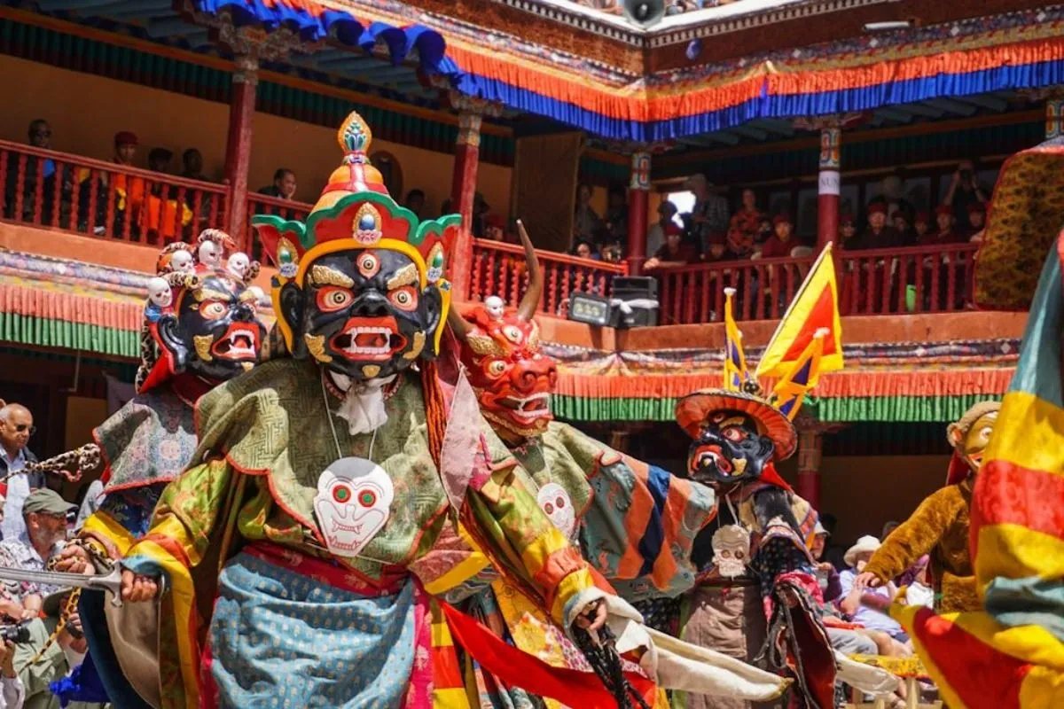 Masked cham dancers in a Ladakhi monastery courtyard