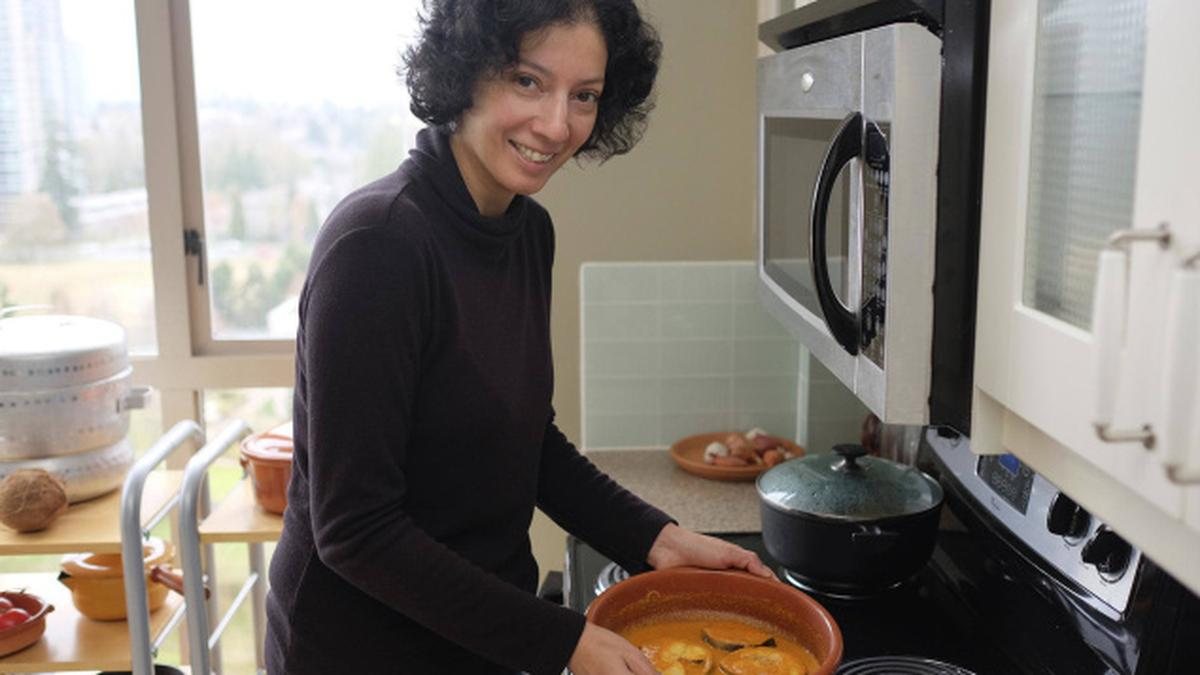 A home cook serving a dish she has just finished cooking
