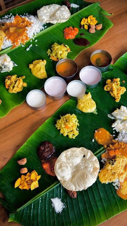 A Kerala sadhya laid out in courses on a banana leaf