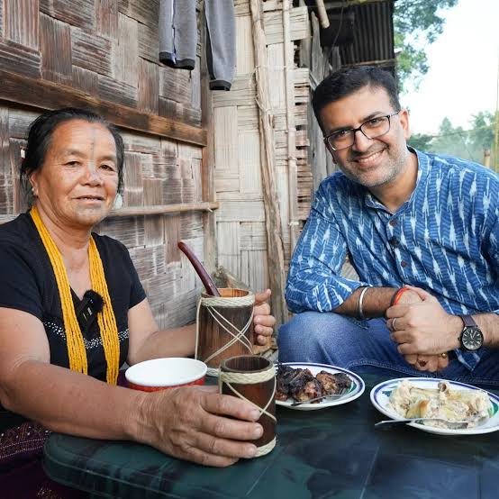 Two people sharing rice beer at a home in Ziro Valley